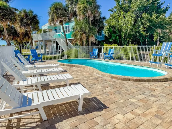 a view of yard with swimming pool and seating space