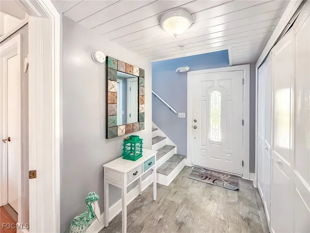 a view of an entryway with wooden floor