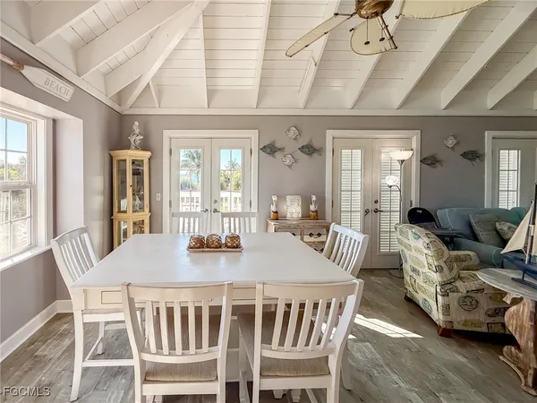 a view of a dining room with furniture wooden floor and chandelier
