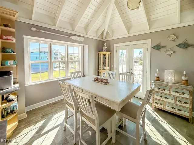 a view of a dining room with furniture and chandelier
