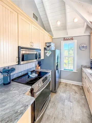 a living room with furniture a fireplace and a table