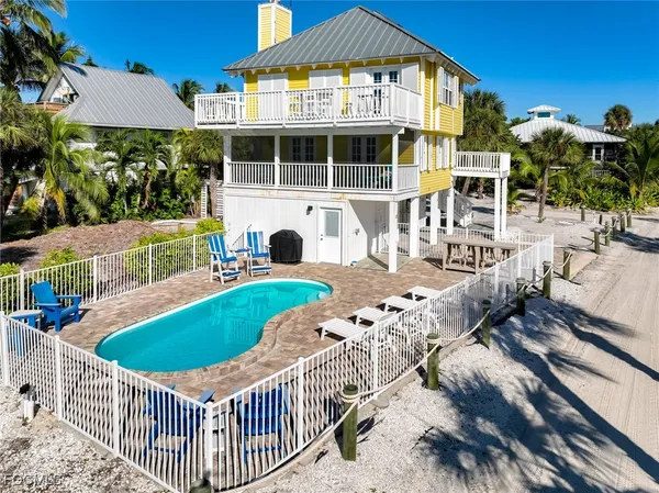 a view of an house with backyard and sitting area