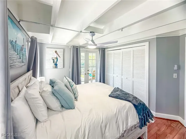 a large bed sitting in a bedroom next to a window