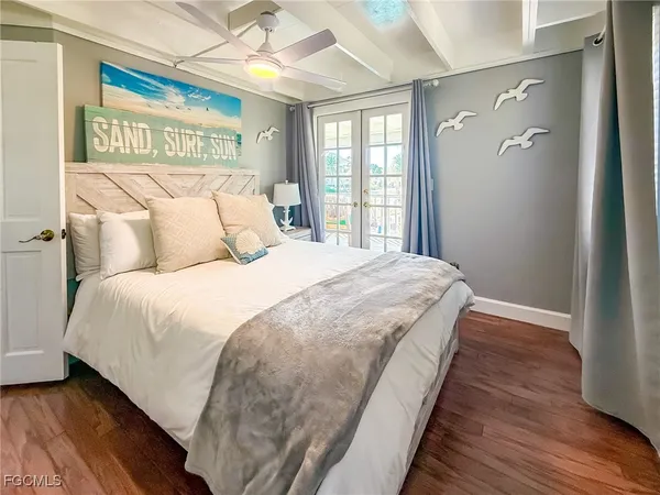 a bedroom with a large bed and a chandelier
