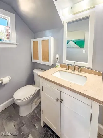 a bathroom with a granite countertop sink a mirror and a shower