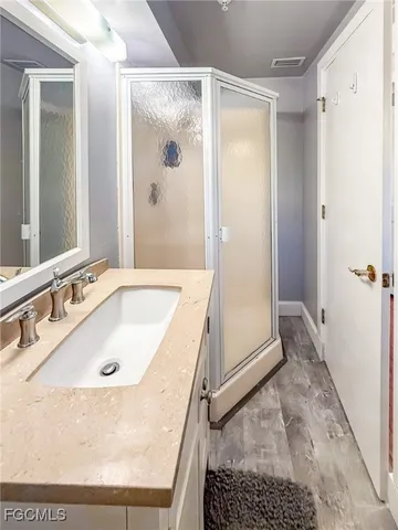 a balcony with wooden floor and outdoor seating