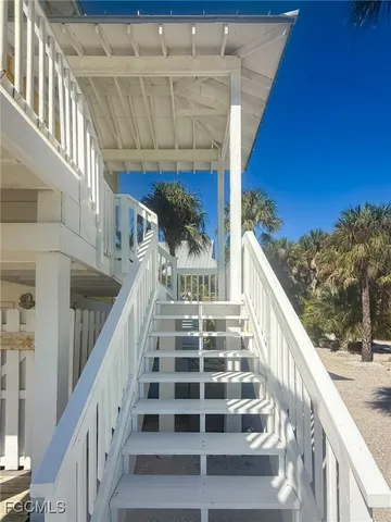 a view of a balcony with wooden floor and iron stairs