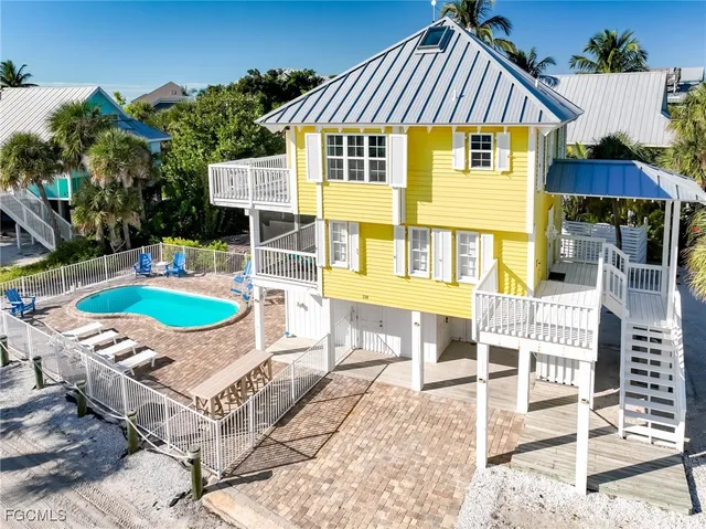 an aerial view of a house with a yard table and chairs