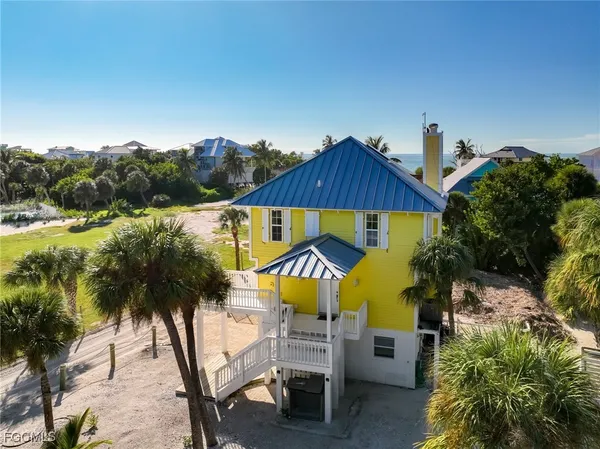 an aerial view of a house with swimming pool and garden