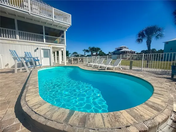 a view of a swimming pool with a lounge chair