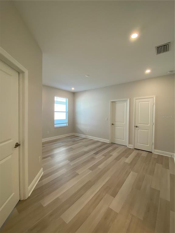 34273 Radley Way Wesley Chapel, FL 33545 - Photo 11 of 38 an empty room with window and pillar in it