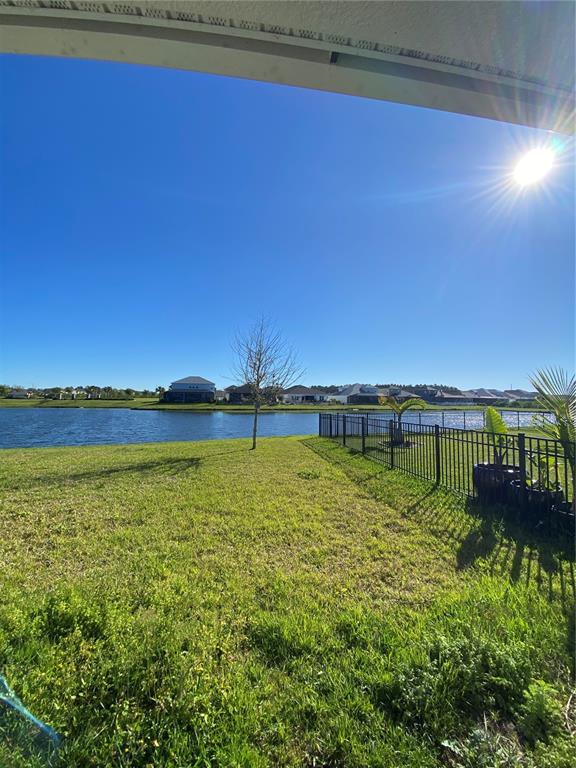 34273 Radley Way Wesley Chapel, FL 33545 - Photo 31 of 38 a view of a lake with houses in the back