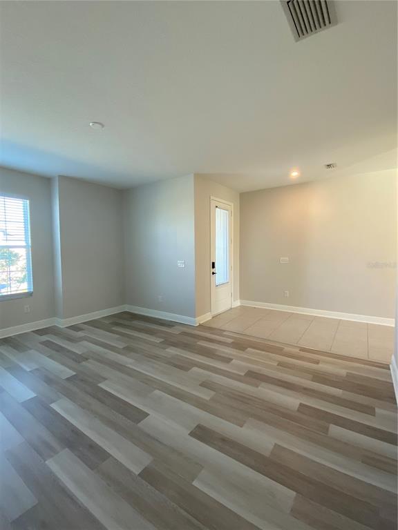 34273 Radley Way Wesley Chapel, FL 33545 - Photo 5 of 38 a view of empty room with wooden floor