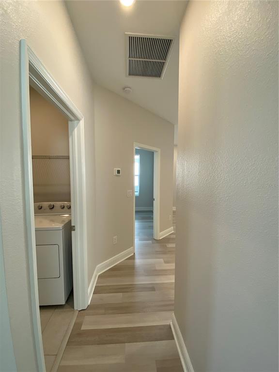 34273 Radley Way Wesley Chapel, FL 33545 - Photo 10 of 38 a view of a hallway with wooden floor and a bathroom