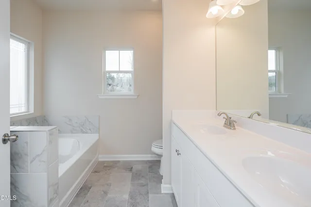 a bathroom with a sink a toilet and tub