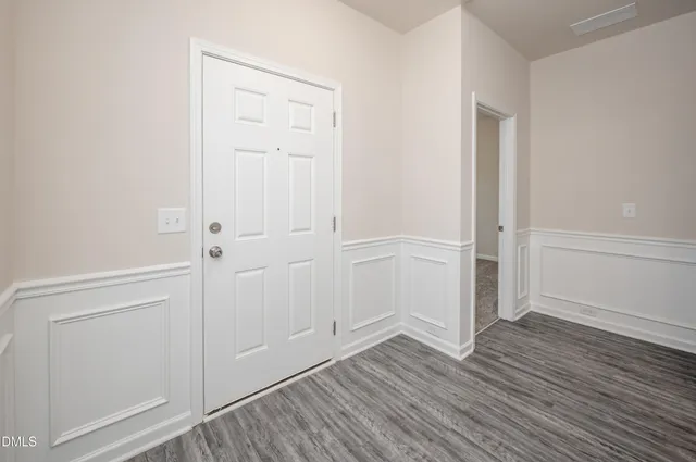 an empty room with wooden floor