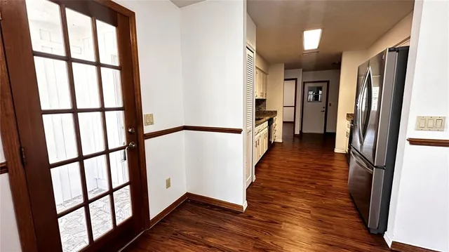 a kitchen with stainless steel appliances granite countertop a stove a sink and a refrigerator
