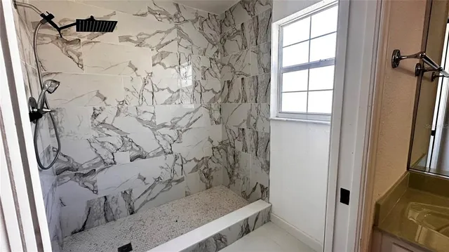 an empty room with a ceiling fan and window