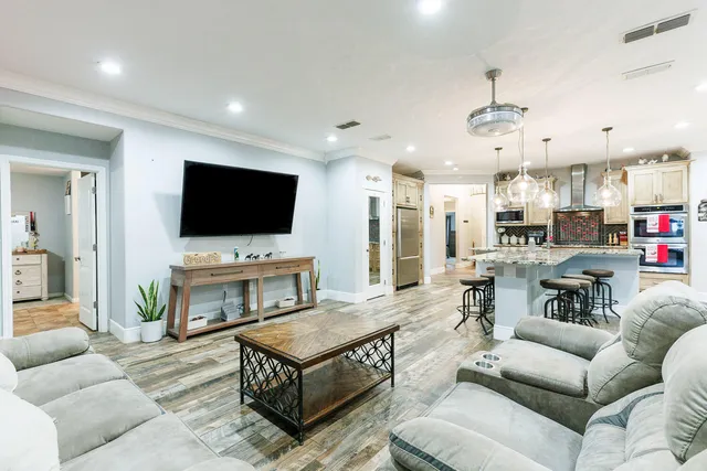 a bathroom with a granite countertop sink a mirror and shower