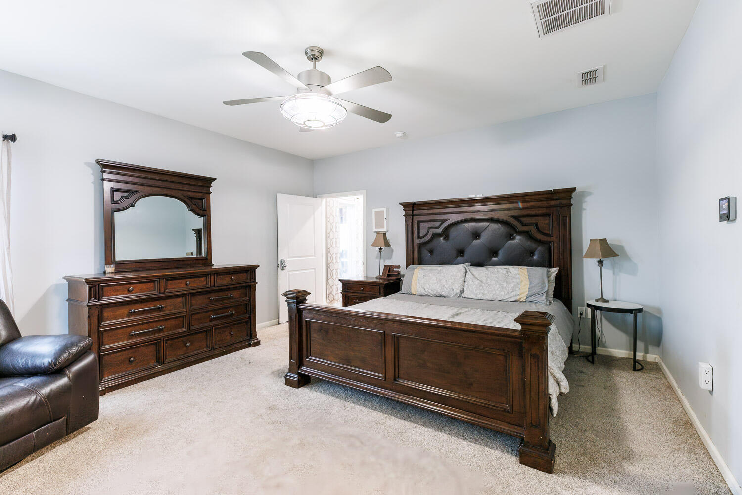 6523 East C R 6200 Lubbock, TX 79403 - Photo 31 of 86 a bedroom with a bed and a chandelier