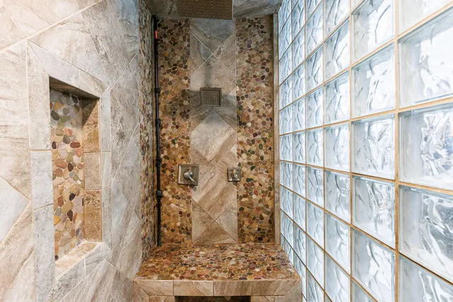 a en suite bathroom with a granite countertop sink and a mirror