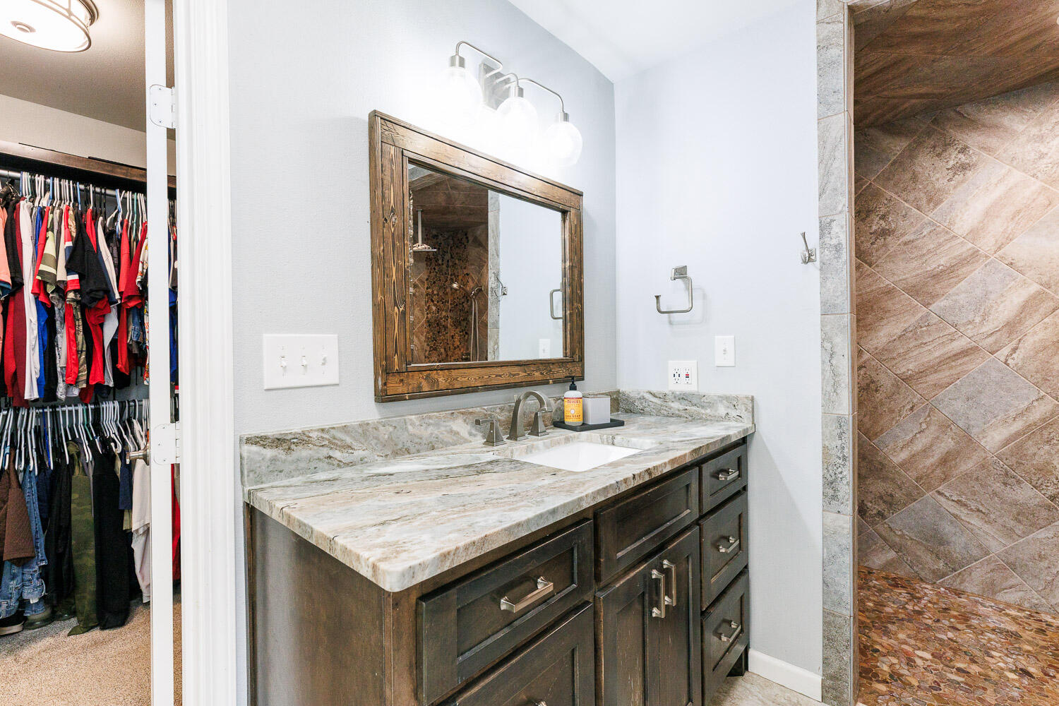 6523 East C R 6200 Lubbock, TX 79403 - Photo 39 of 86 a bathroom with a granite countertop sink and a mirror