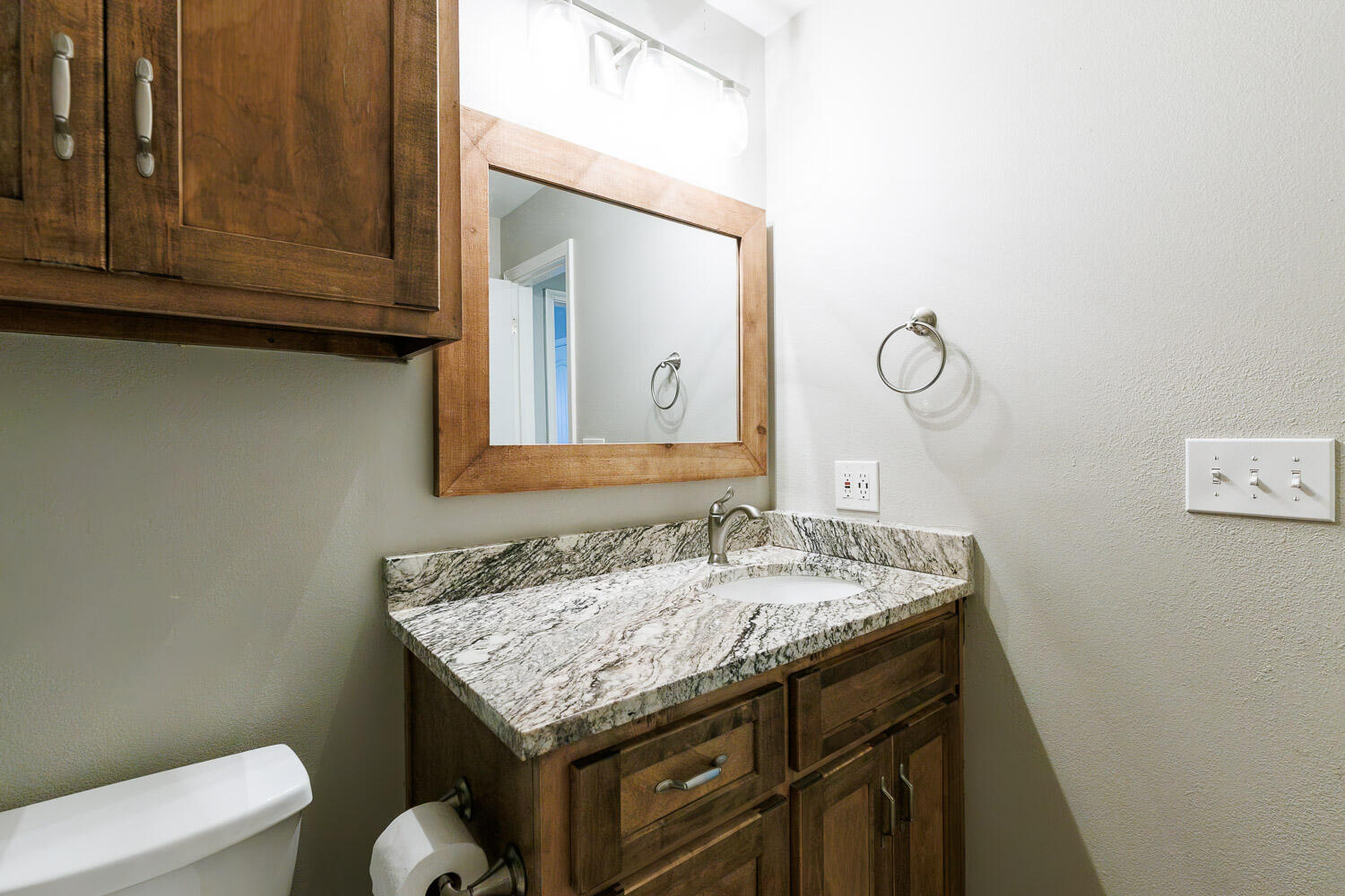 6523 East C R 6200 Lubbock, TX 79403 - Photo 47 of 86 a bathroom with a granite countertop sink and a mirror