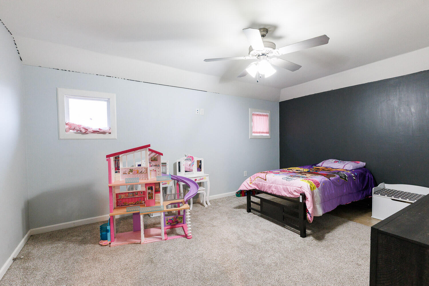 6523 East C R 6200 Lubbock, TX 79403 - Photo 48 of 86 a bedroom with a bed and a chandelier