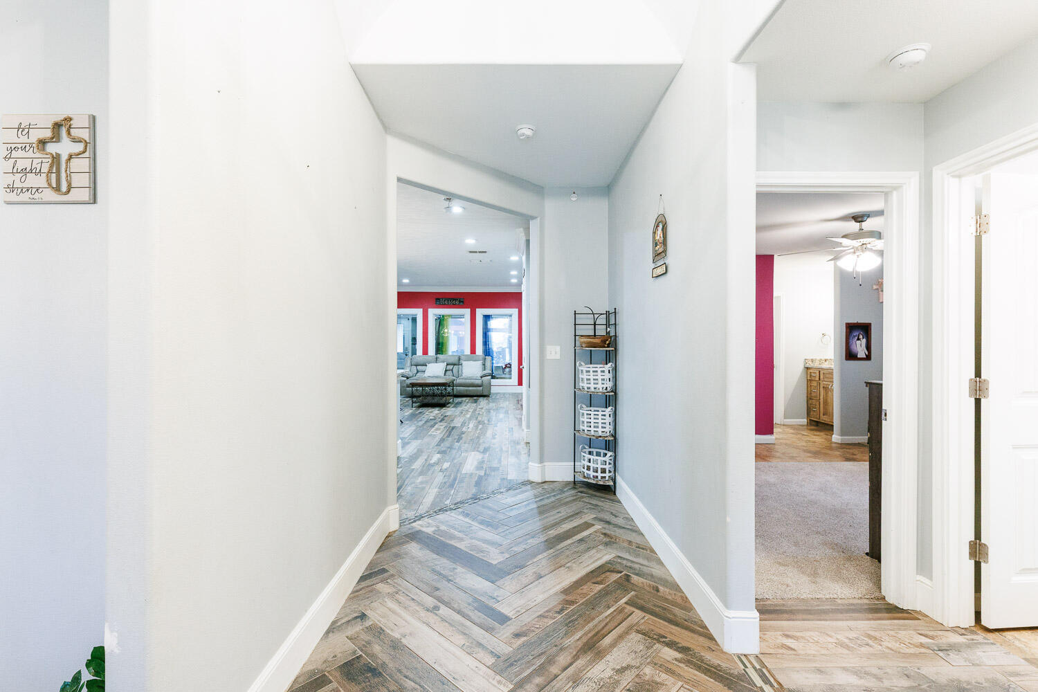 6523 East C R 6200 Lubbock, TX 79403 - Photo 6 of 86 a view of a hallway with wooden floor and a bathroom