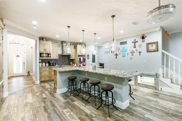 a kitchen with stainless steel appliances granite countertop a refrigerator and a sink
