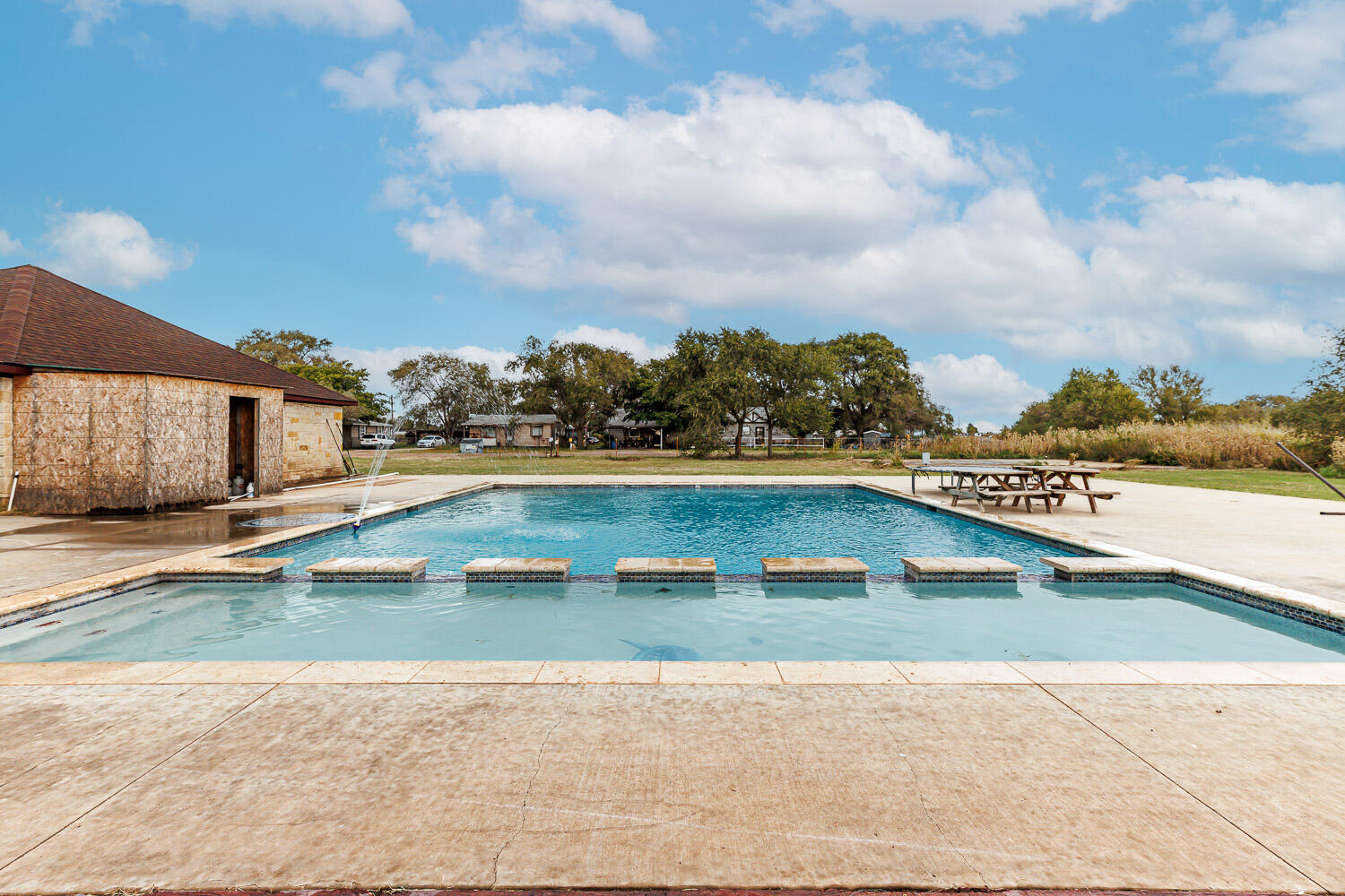 6523 East C R 6200 Lubbock, TX 79403 - Photo 73 of 86 a view of a swimming pool and an outdoor seating