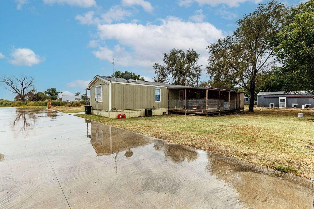 6523 East C R 6200 Lubbock, TX 79403 - Photo 86 of 86 a view of a swimming pool with a chair and tables
