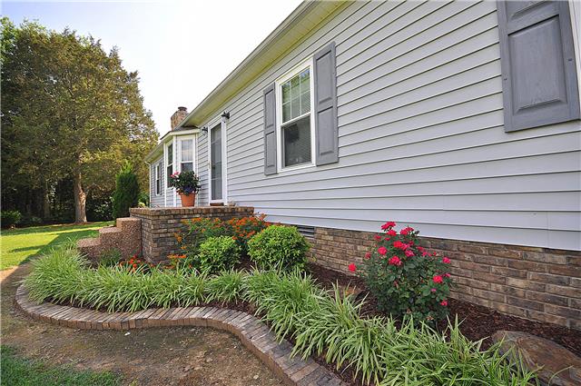 1280 A McCrary Road Lebanon, TN 37090 - Photo 15 of 20 a front view of a house with a yard and a garden