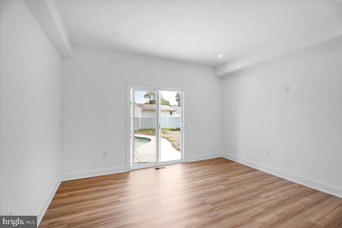 2504 Church Road Cinnaminson, NJ 08077 - Photo 21 of 79 a view of an empty room with wooden floor and glass door