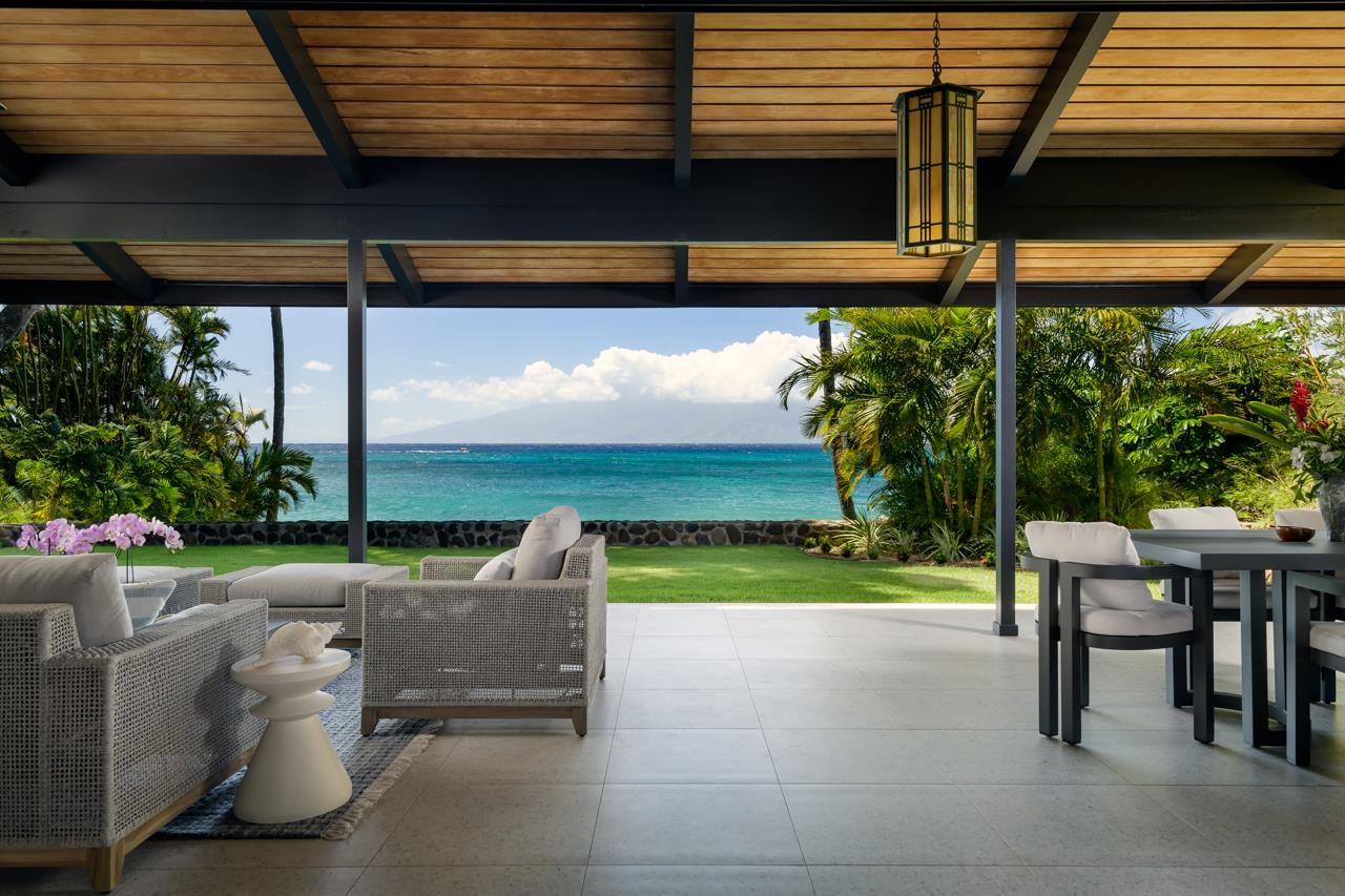 4885 Lower Honoapiilani Road Lahaina, HI 96761 - Photo 1 of 37 a view of a patio with table and chairs and potted plants