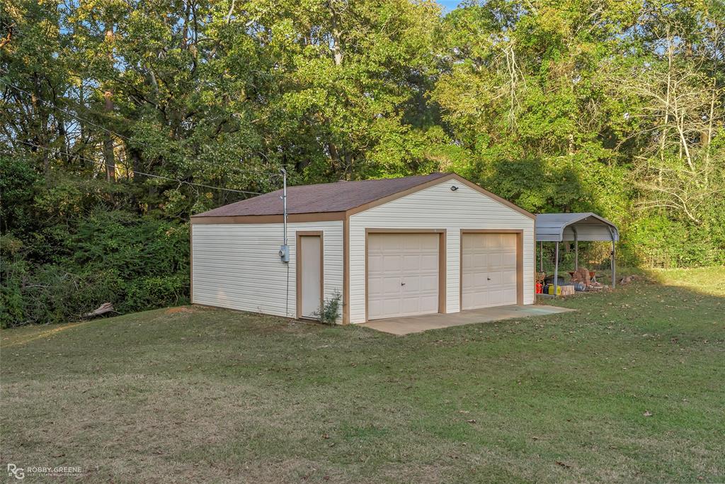 169 Fulbright Circle Minden, LA 71055 - Photo 13 of 38 a front view of a house with a yard and trees