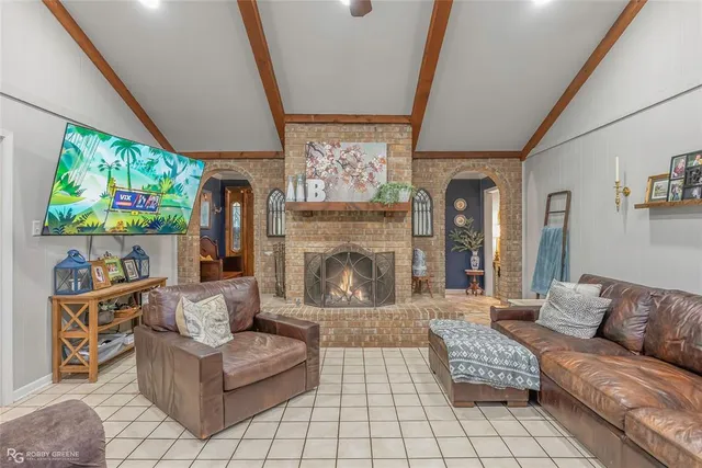 a living room with furniture and a fireplace