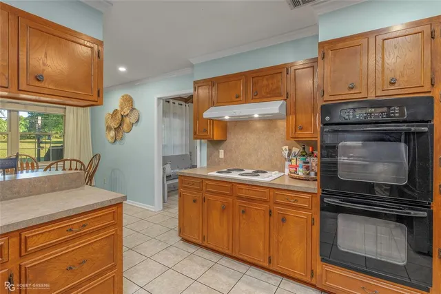 a kitchen with stainless steel appliances granite countertop a refrigerator and cabinets