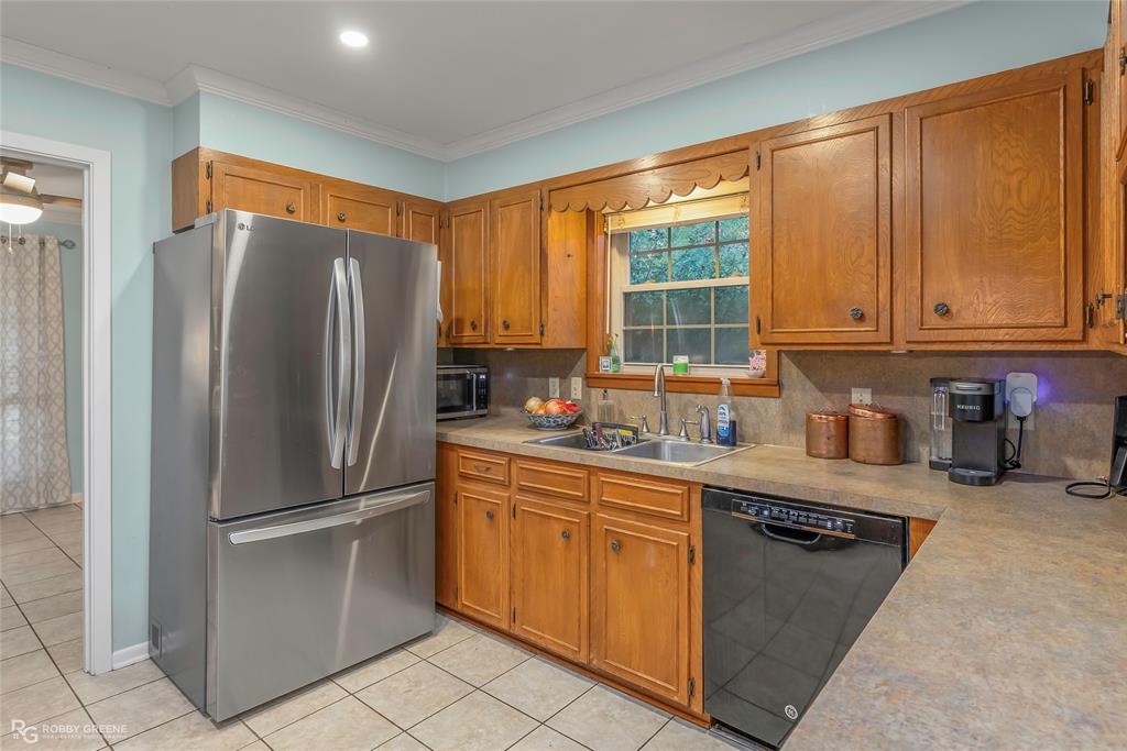 169 Fulbright Circle Minden, LA 71055 - Photo 25 of 38 a kitchen with stainless steel appliances granite countertop a refrigerator and a sink