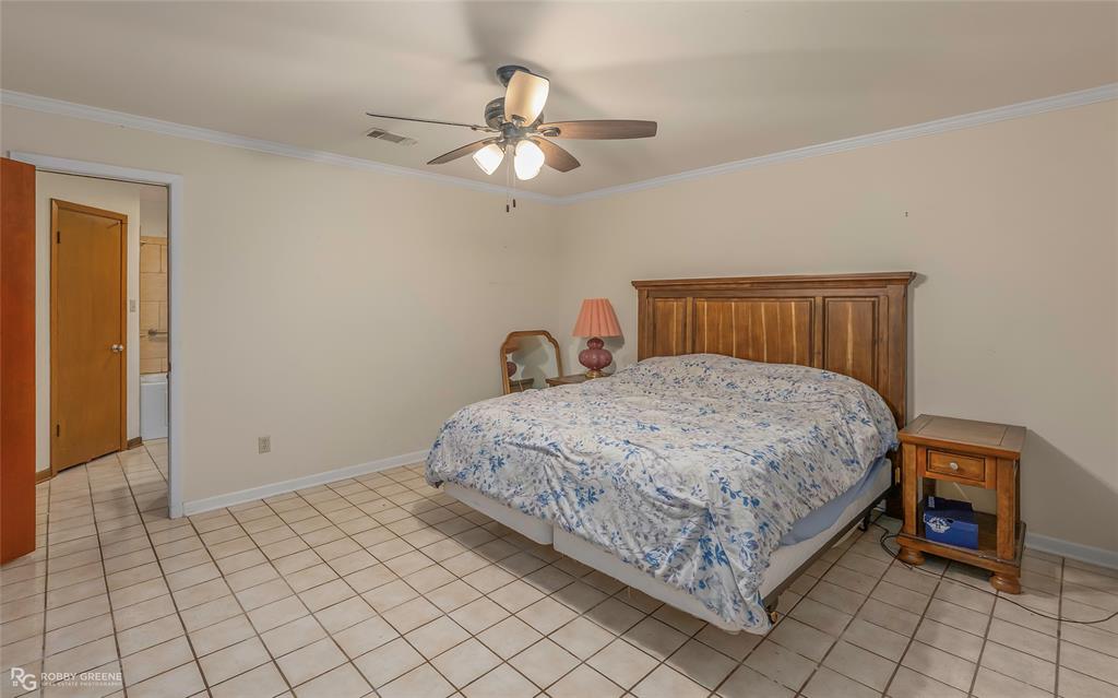 169 Fulbright Circle Minden, LA 71055 - Photo 27 of 38 a bedroom with a bed and a chandelier