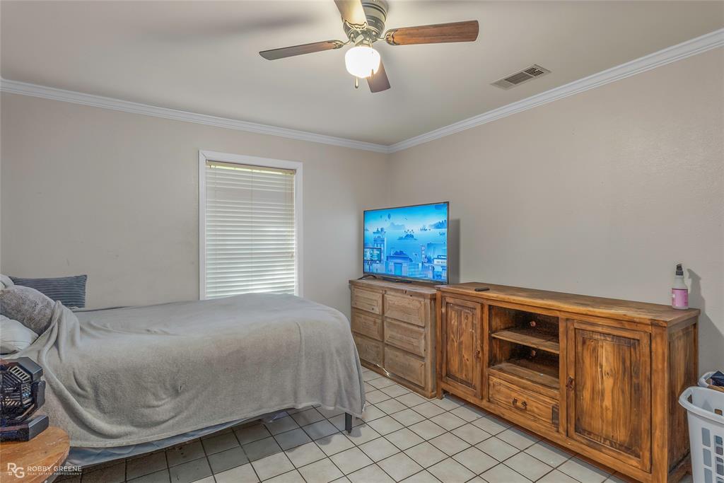 169 Fulbright Circle Minden, LA 71055 - Photo 32 of 38 a bedroom with furniture and a chandelier