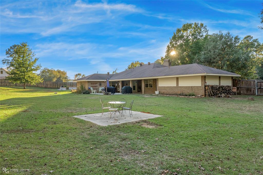 169 Fulbright Circle Minden, LA 71055 - Photo 4 of 38 a front view of a house with a yard table and chairs