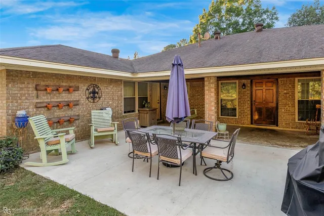 a view of a patio with table and chairs