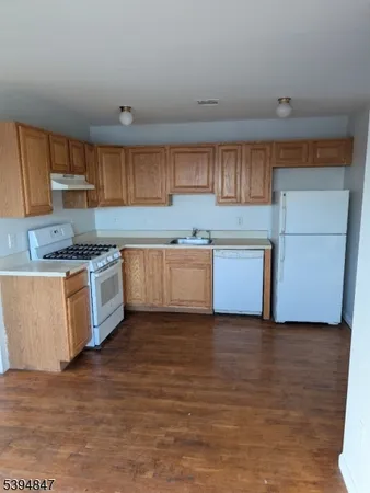 a kitchen with stainless steel appliances granite countertop a sink and a stove