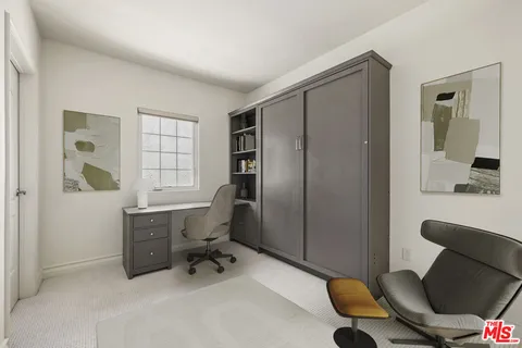 a view of a livingroom with workspace and a window