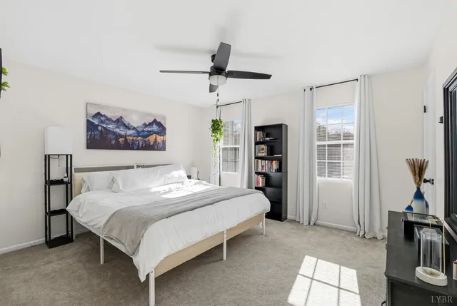 a bedroom with a bed flat screen tv and a window