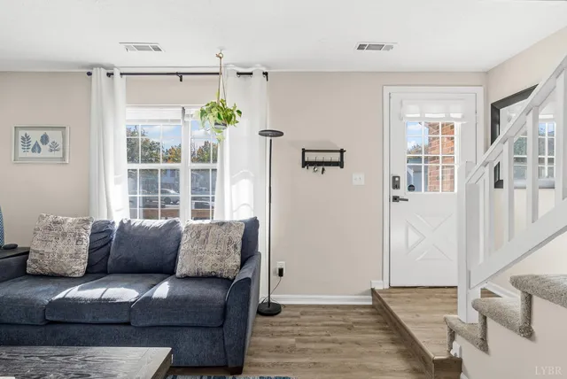 a living room with furniture and a large window
