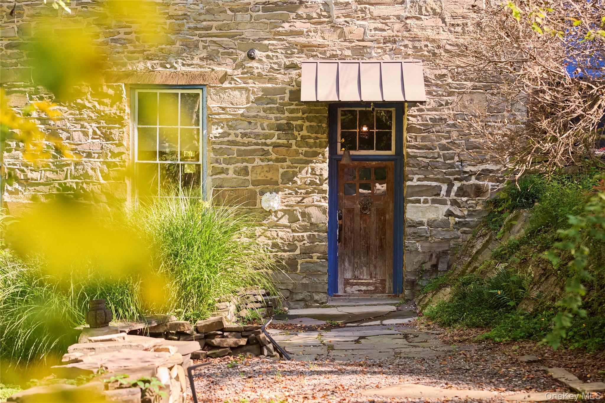 1883 Highway 213 Rifton, NY 12471 - Photo 11 of 48 Doorway to property with stone siding, a standing seam roof, and a metal roof