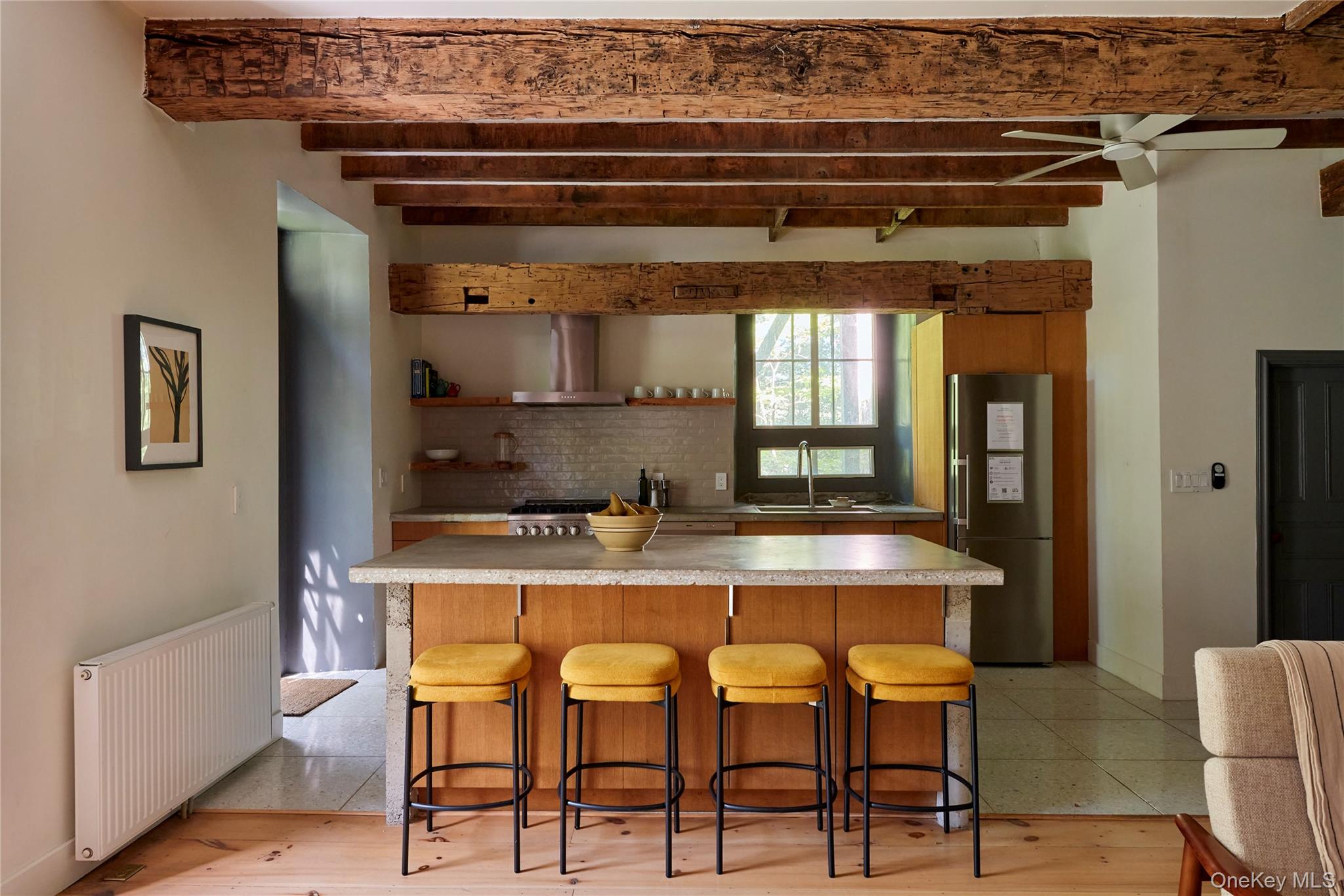1883 Highway 213 Rifton, NY 12471 - Photo 15 of 48 Kitchen with radiator heating unit, a kitchen breakfast bar, light countertops, stainless steel appliances, and beamed ceiling