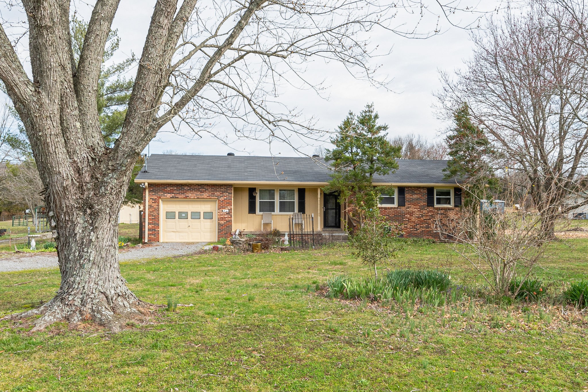 765 Lindsley Road Lebanon, TN 37090 - Photo 2 of 32 a front view of a house with a garden and trees